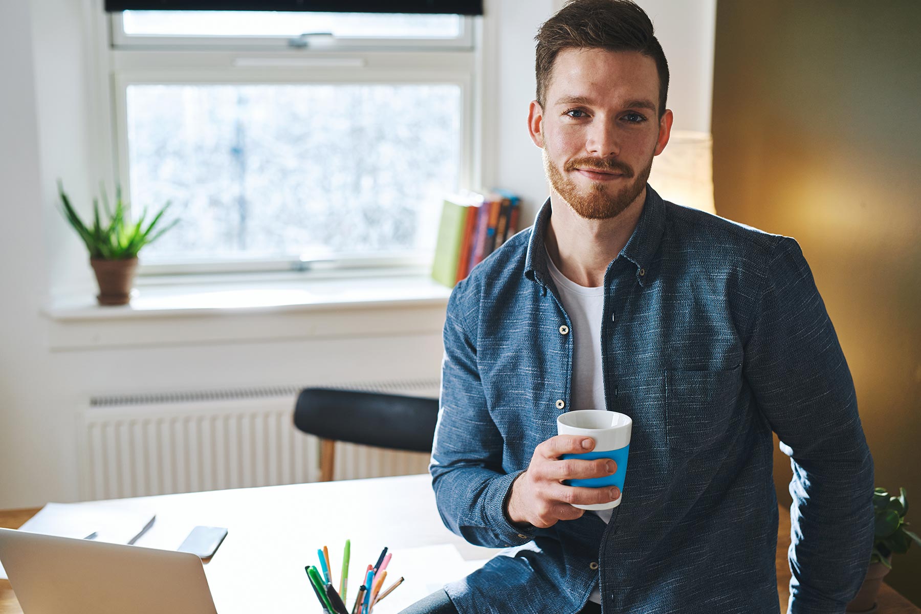 young-entrepreneur-sitting-in-his-office-F7Y2RBG.jpg